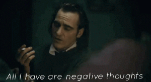Arthur is speaking whilst holding a lit cigarette. Writing over the image say: All I have are negative thoughts