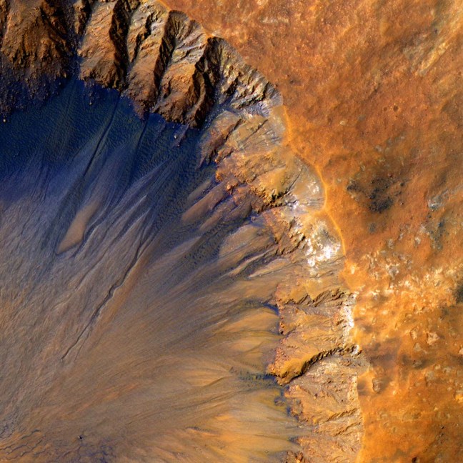 Sirenum fossae, a qudrangle of Mars. It looks like a giant crator on the bright red landscape