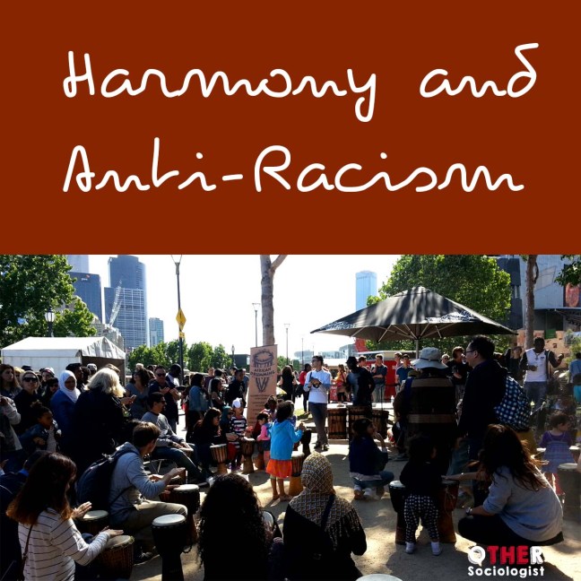 Crowd gathers at a multiculturalism event, including women in hijab and children playing drums