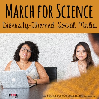 Two women of colour sit behind a table in the background with a laptop open, they are smiling and talking with another person out of focus in the foreground