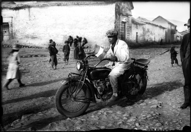 Quechuan man rides a bike in the 1900s