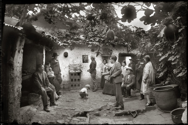 Quechuan family drink "chicha" (a sweet drink) and play "sapo" (a coin toss game)