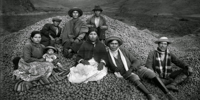 Quechuan family sit on a mound of rocks