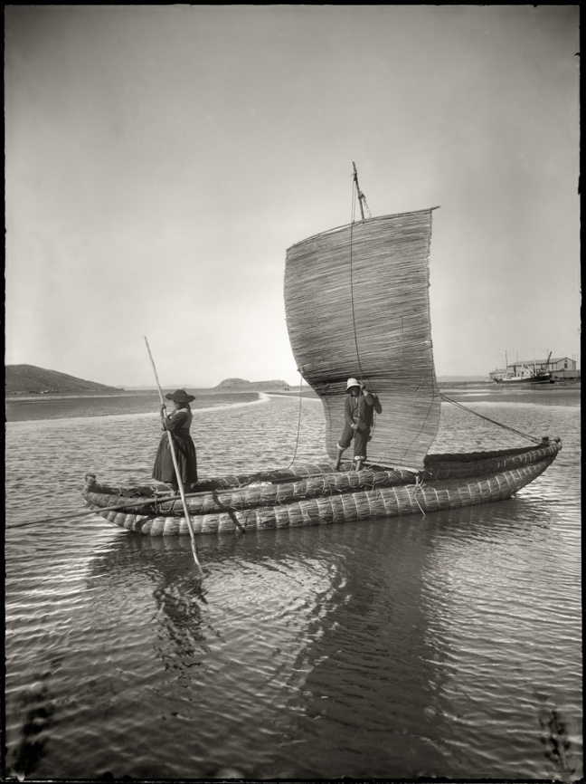 Quechuan people steer a boat