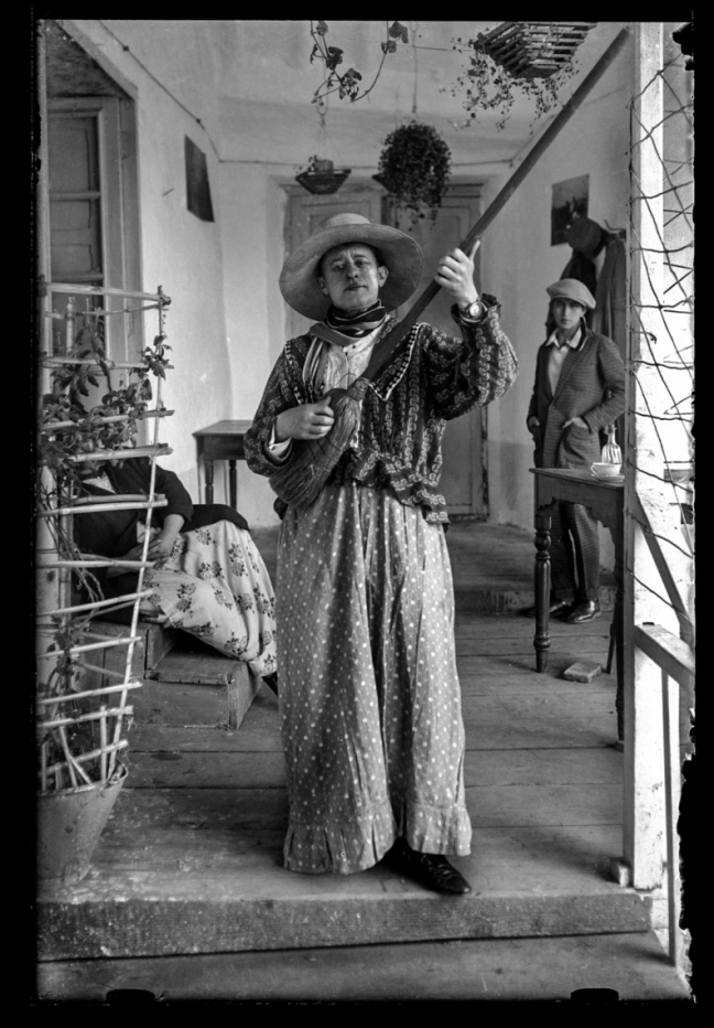 Quechuan woman pretends to play a broom like a guitar