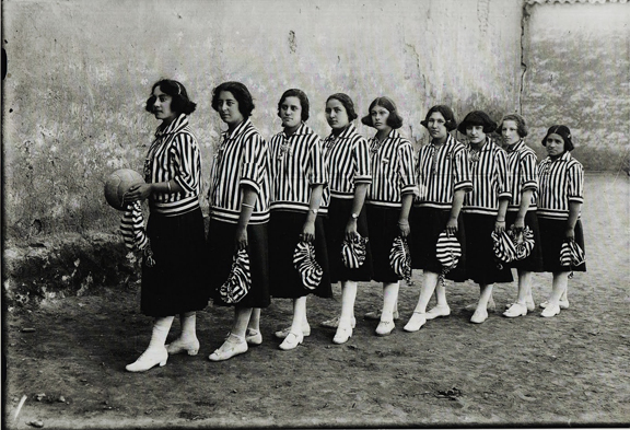 Quechuan women dressed in sports uniform from early 1920s. One of them holds a futbal