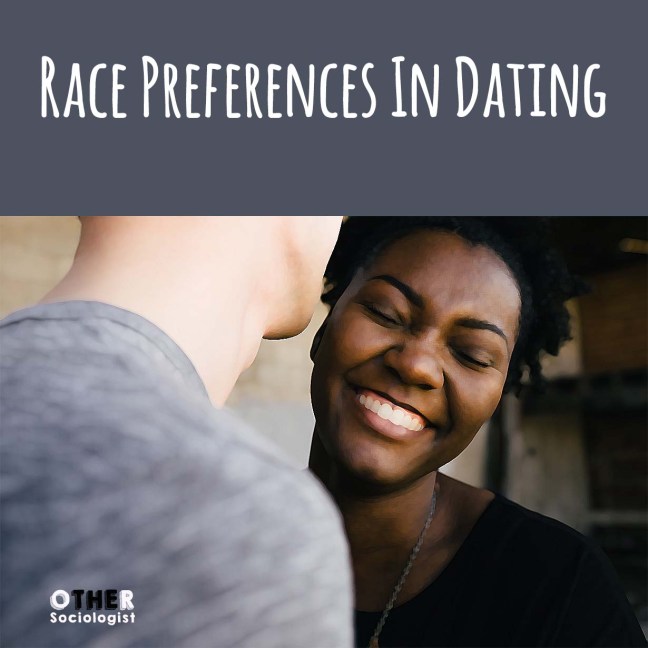 A White man leans into the ear of a Black woman who is laughing with he eyes closed