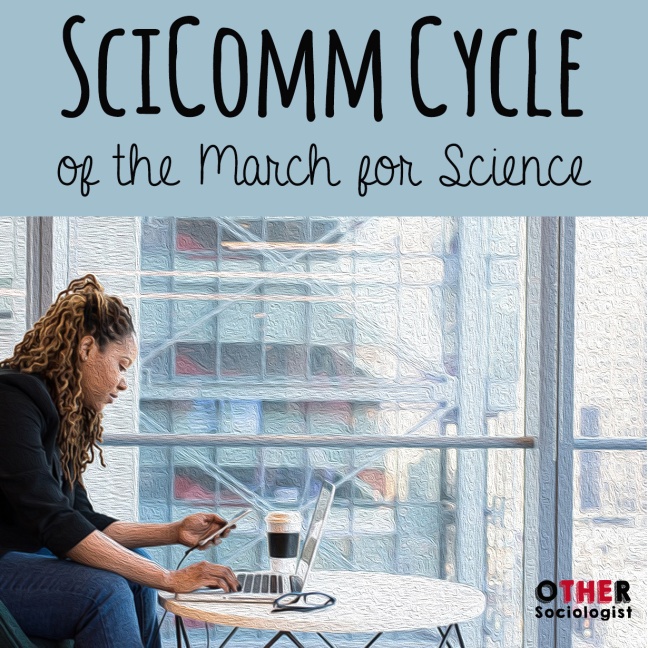 Woman of colour reads her phone in front of a laptop